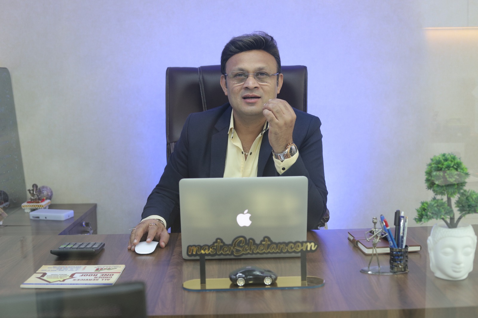 Professional sitting at an office desk working on a computer in a modern workspace